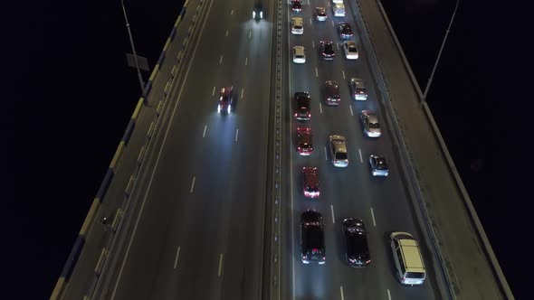 Aerial Shot of Traffic Jam on the Bridge at Night Time. alt