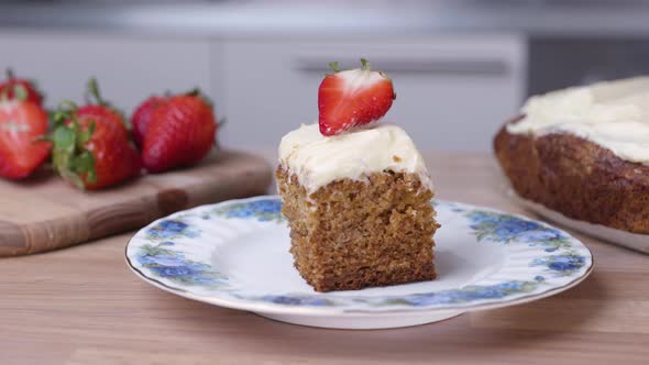 Portion Of Baked Carrot Cake With Fresh Sliced Strawberry On The Top - close up alt