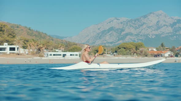 Girl In Kayak Summer Trip. Woman Exploring Calm Sea By Canoe On Holiday Vacation Weekend. alt