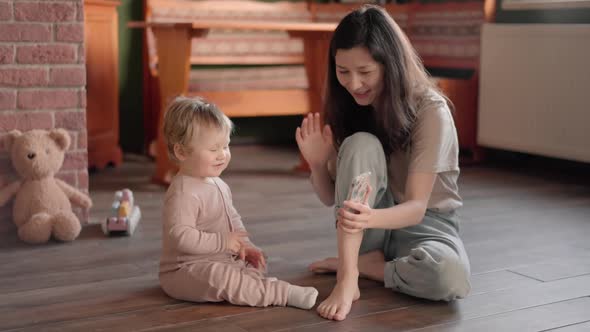Mother and Baby Having Video Chat Using Smartphone Waving at Infant Enjoying Communicating Family alt