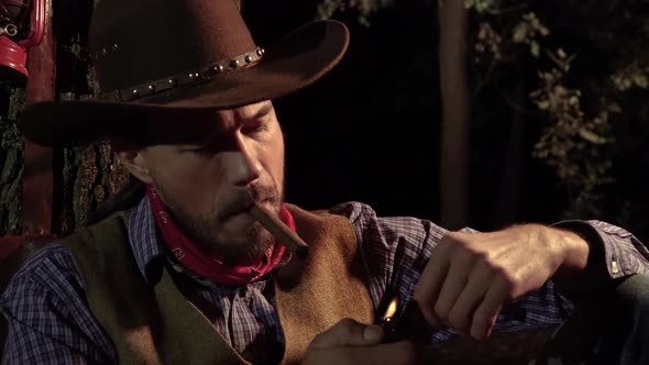 The Cowboy Smokes a Cigar in the Forest at Night alt