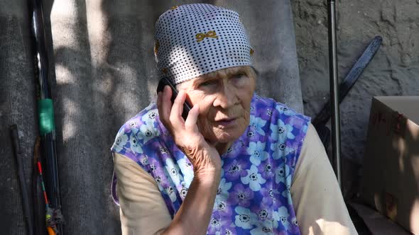 Slavic Senior Rural Woman Using Phone at Village