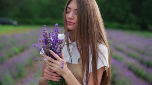 Happy Girl Posing with Lavender Bouquet in Field alt