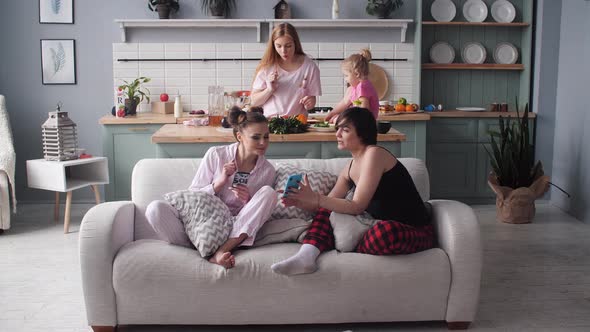 Front View of Family Sitting in Modern Kitchen in Morning