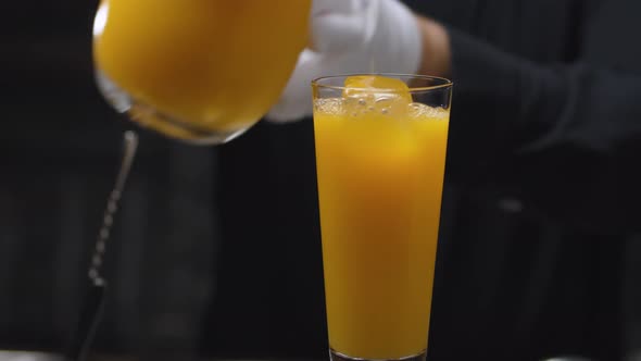 Preparing a Tequila Sunrise Cocktail alt