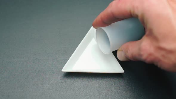 Close-up of Pouring Jewelry Beads Into a Plate alt