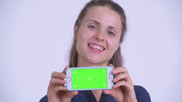 Face of Happy Young Beautiful Businesswoman Showing Phone alt