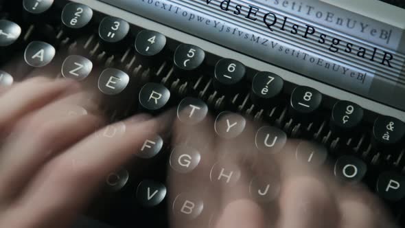 A man typing on a typewriter