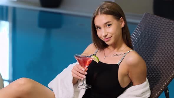Sexy young woman in bathing suit with cocktail