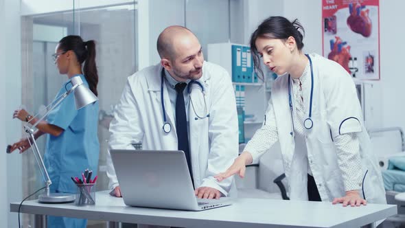 Two Colleagues Doctors Consulting Over a Problem alt