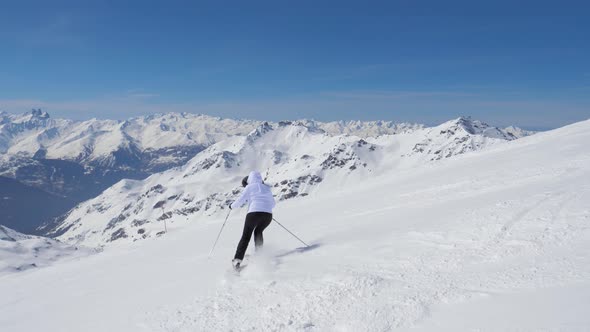 Skier Skiing Down Snowy Piste In Mountain Slope In Winter On Skis alt