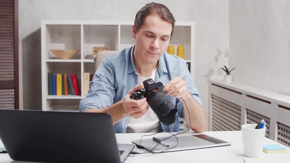 Workplace of freelance worker at home office. Young man works using computer. alt