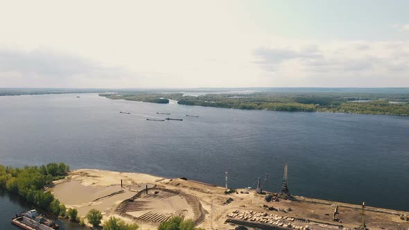 Construction River Port, View From a Quadcopter. Construction Cranes and Equipment Stands on the