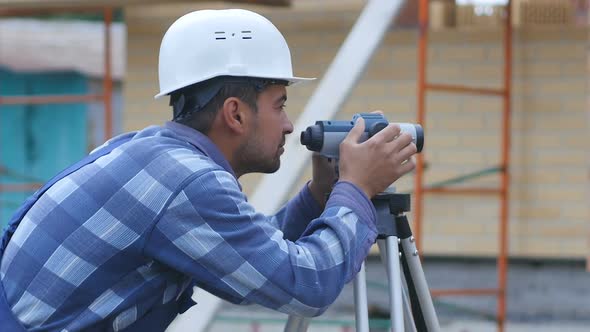 Male Construction Worker Working with Theodolite, Level Tool