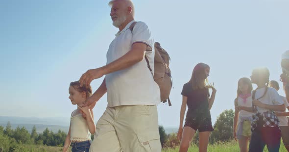 Children with Teacher Hiking in Mountains at Warm Summer Day alt