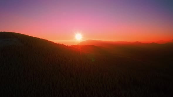 Aerial view of Winter mountain During sunrise or sunset. Pink, magenta colored Sky alt