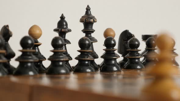 Close-up of chess set figures arranged on  table 4K 2160p 30fps UltraHD  footage - Black player wood alt