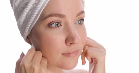 Closeup of a Face of a Young Beautiful European Woman with a White Towel on Her Head Touching Her