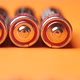 Close Up of Batteries on Orange Background - VideoHive Item for Sale
