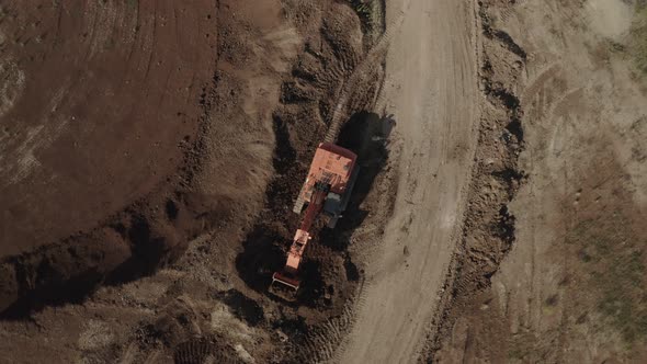 Top View of Excavator Doing Earth Works at Clay Quarry