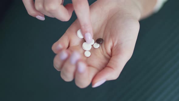 Organic and Natural Medicines. Pills in the Hand of a Female Young Palm. Ginseng, Calcium, Vitamins