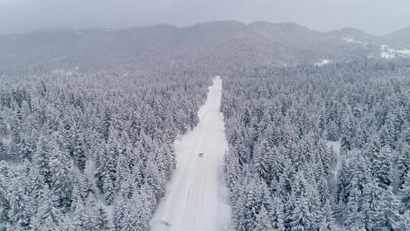 Car Traveling On Snowy Road