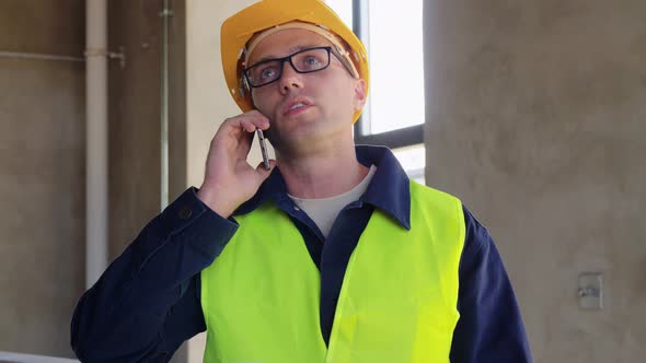 Angry Builder Calling on Smartphone at Office