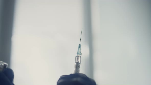 Medicine Syringe Fulled Drug in Doctor Hands Close Up alt