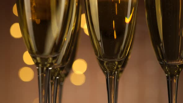 champagne glasses over Holiday Bokeh Blinking background rotating