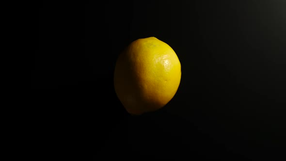 Lemon Rotates On A Black Surface
