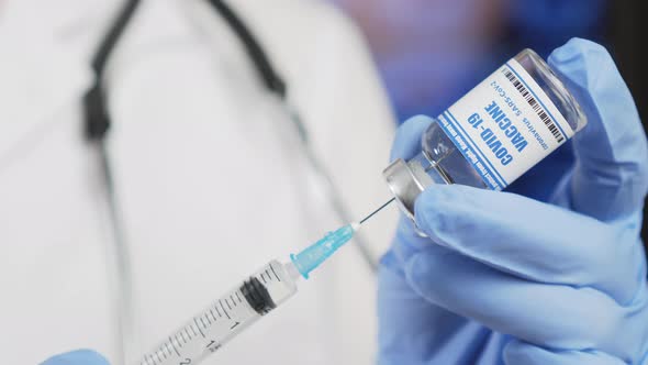 Taking COVID-19 vaccine into syringe. Doctors create invent coronavirus vaccine