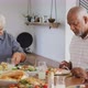 Happy senior diverse people having dinner at retirement home - VideoHive Item for Sale