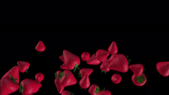 THE MOVEMENT of fresh strawberries falling on a black background
