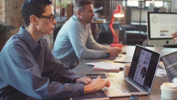 Businesswoman Using Laptop at Office Coworking Table alt