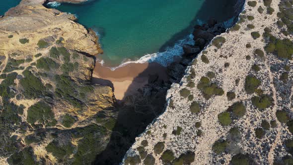 Aerial footage of the cliffs and beach in Sagres Portugal.