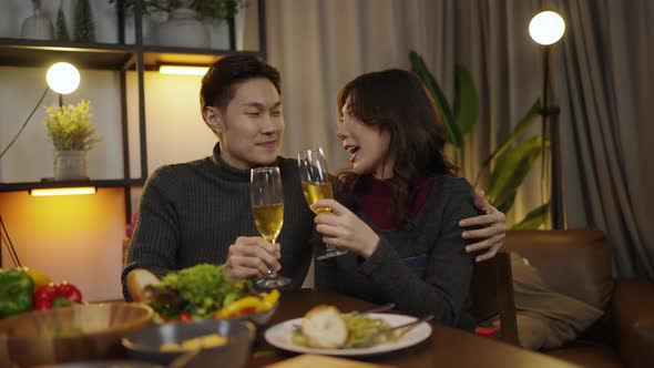 Asian family having dinner at dining table at home