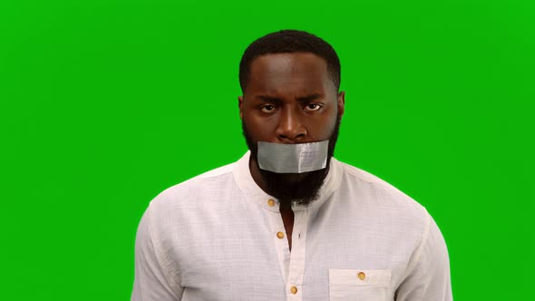 No to racism. I have a voice. Disgruntled man with adhesive tape, taped to his mouth. Alpha channel