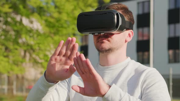 Man Wearing Virtual Reality Headset and Manage the Interface in Augmented Reality alt