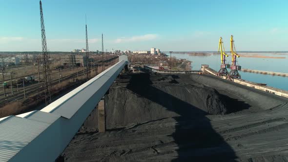 Aerial View of Open Coal Warehouse Near River with Crane and Conveyor