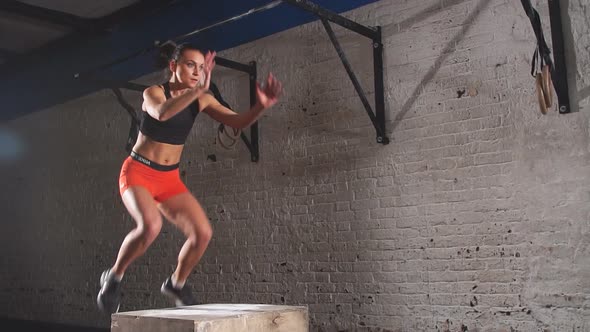Young Athletic Woman Jumping Up on the Box. Slow Motion. alt