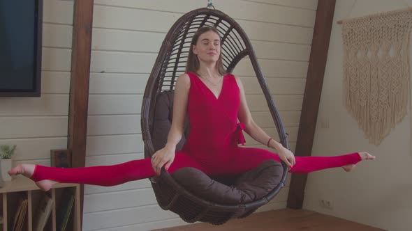 Cute Sporty Fit Woman Doing Splits in Swing Chair alt