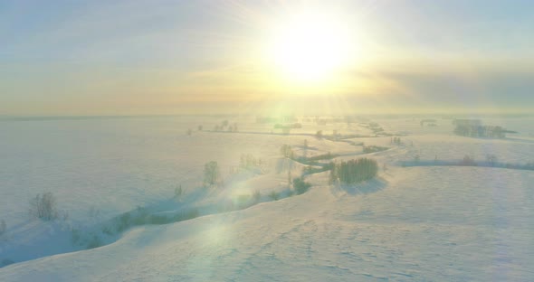 Aerial View of Cold Winter Landscape Arctic Field Trees Covered with Frost Snow Ice River and Sun alt