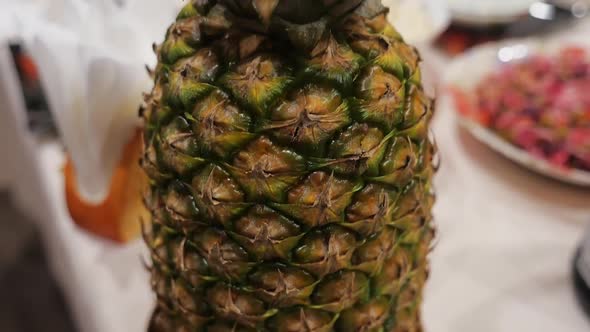 Close-up of pineapple on the kitchen table camera movement from bottom to top alt
