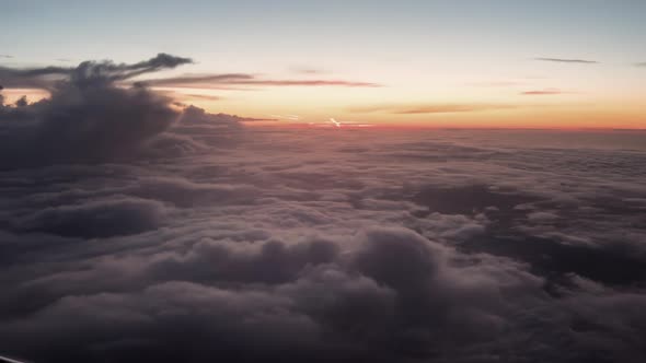 Flight Above Stormy Clouds During Sunset