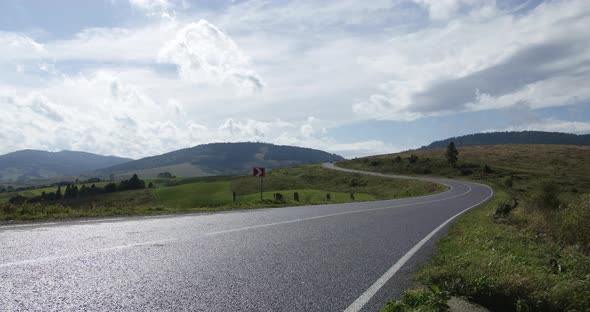 Twisty Road Sign Panning Mountain Road Time-lapse. a Panning Right Time-lapse of a Twisty Road Sign alt