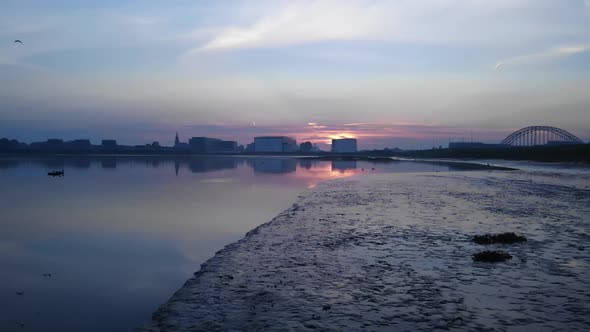 Slowmotion of birds flying during sunrise in the netherlands, Truck shot. alt