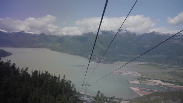 Gondola and metal ropes with beautiful spring view of Howe sound and mountains alt