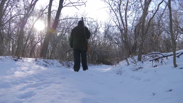 Hunting Hunter Men with Gun Walking Through the Forest During the Hunting Season. alt