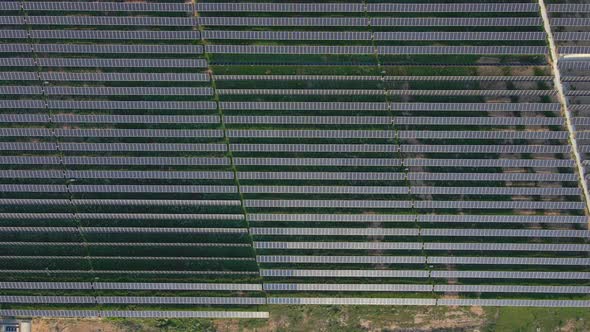 Aerial Shot of a Huge Solar Power Plant in a Big Field. Electricity Generation From Solar Energy alt