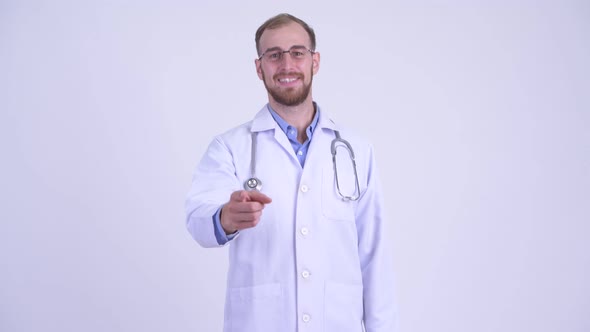 Happy Bearded Man Doctor Pointing at Camera